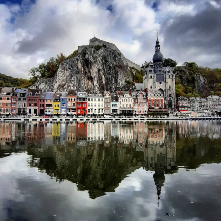 reflection of houses, church and hill of Dinant in the river
