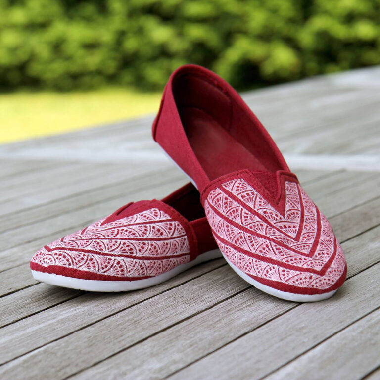 red shoes with white pattern drawn on them