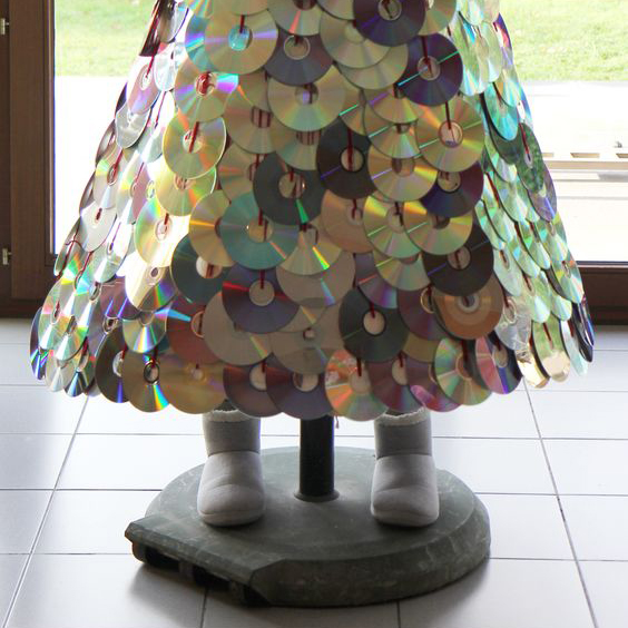 bottom of Christmas tree in shape of a cone covered with CDs
