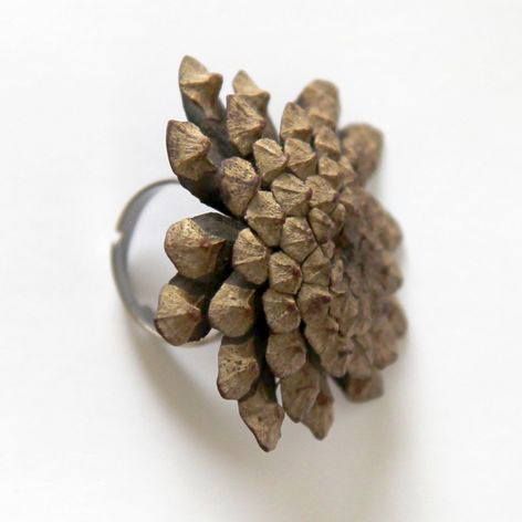 silver ring with pine cone bottom on top